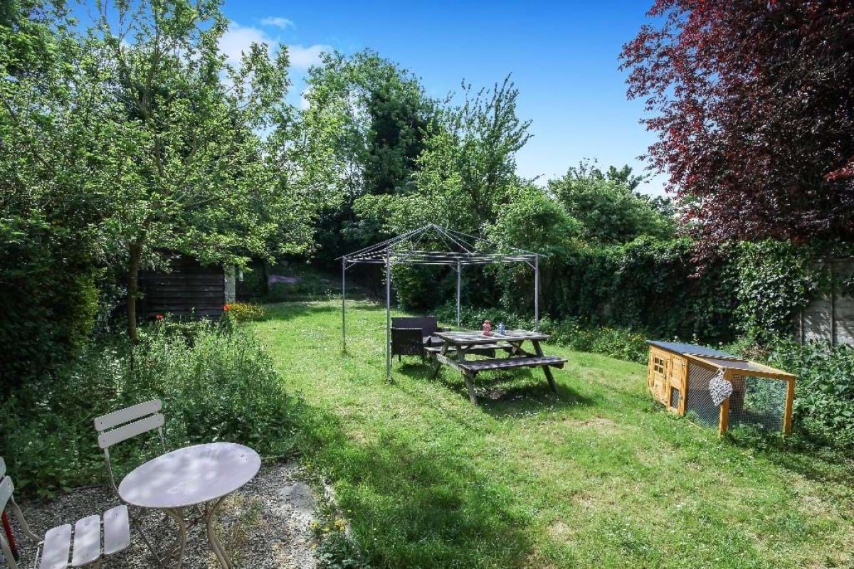 The rear garden at Grove Road, a lawn with fruit trees, a picnic table and a gazebo