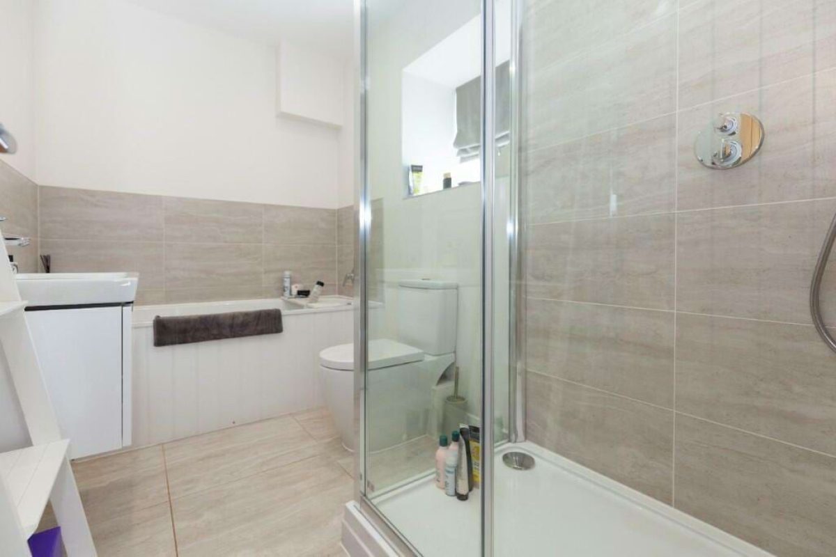 Bathroom at Hordley Farm Barns with a walk-in shower and a bath