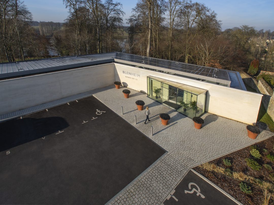 Aerial view of the Estate Office entrance courtyard with planters, glazed doors and accessible parking