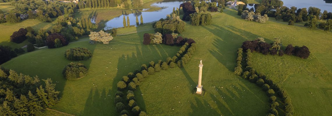 Aerial view of the Column of Victory and its avenues of trees, with the lake and Blenheim Palace beyond