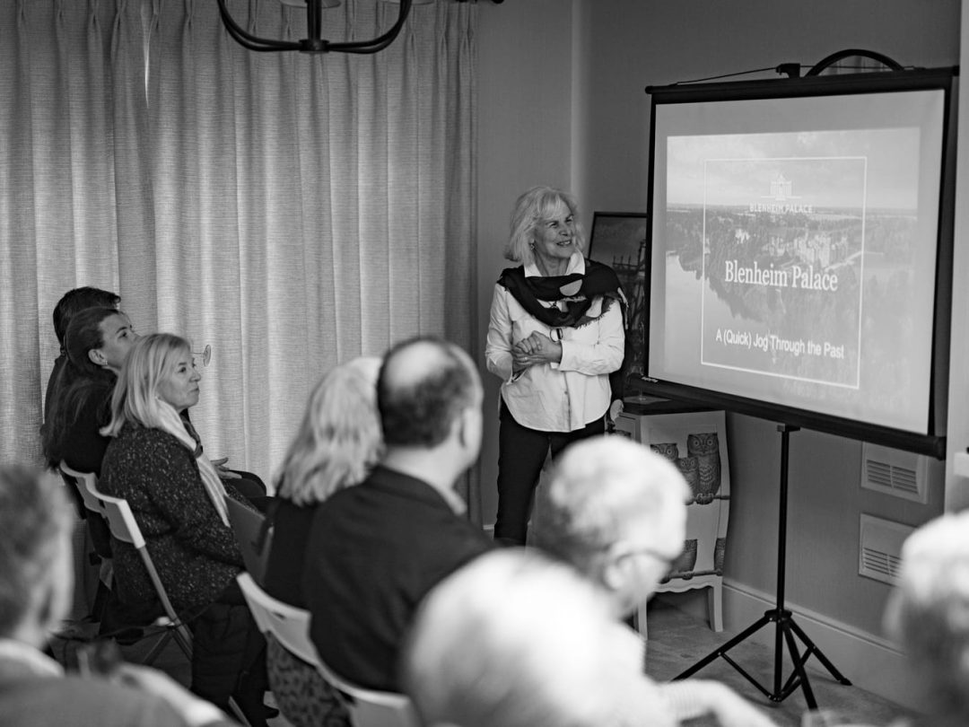 Social historian Antonia Keaney giving a talk on Blenheim Palace to seated Park View residents, in black and white