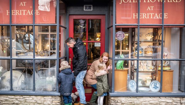 A family looking into the window of the John Howard at Heritage antiques shop in Woodstock