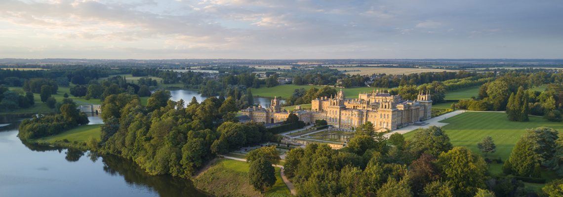 Aerial view of Blenheim Palace and the lake at dawn