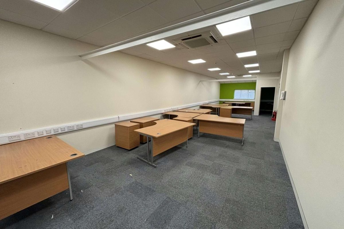 Open-plan office at Brook Hill with wooden desks and grey carpet