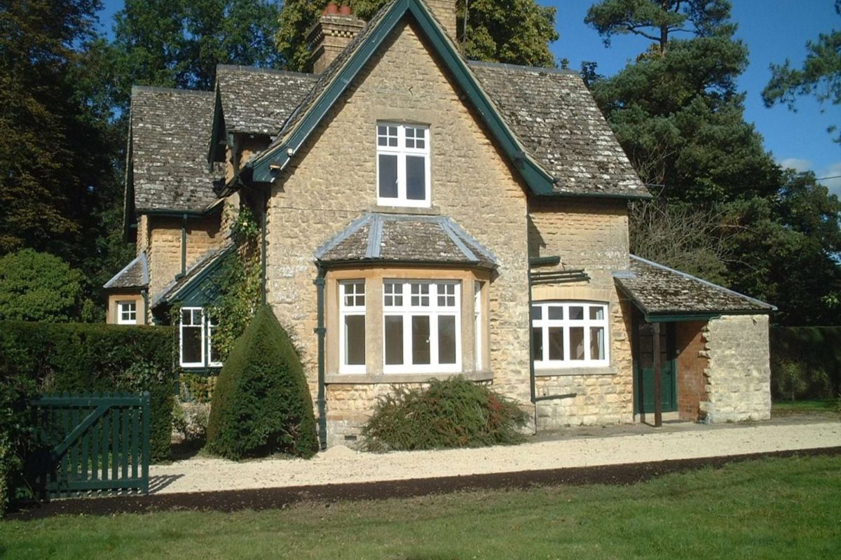Gardens Lodge, a stone lodge with a steep gabled roof, bay window and green-painted gate