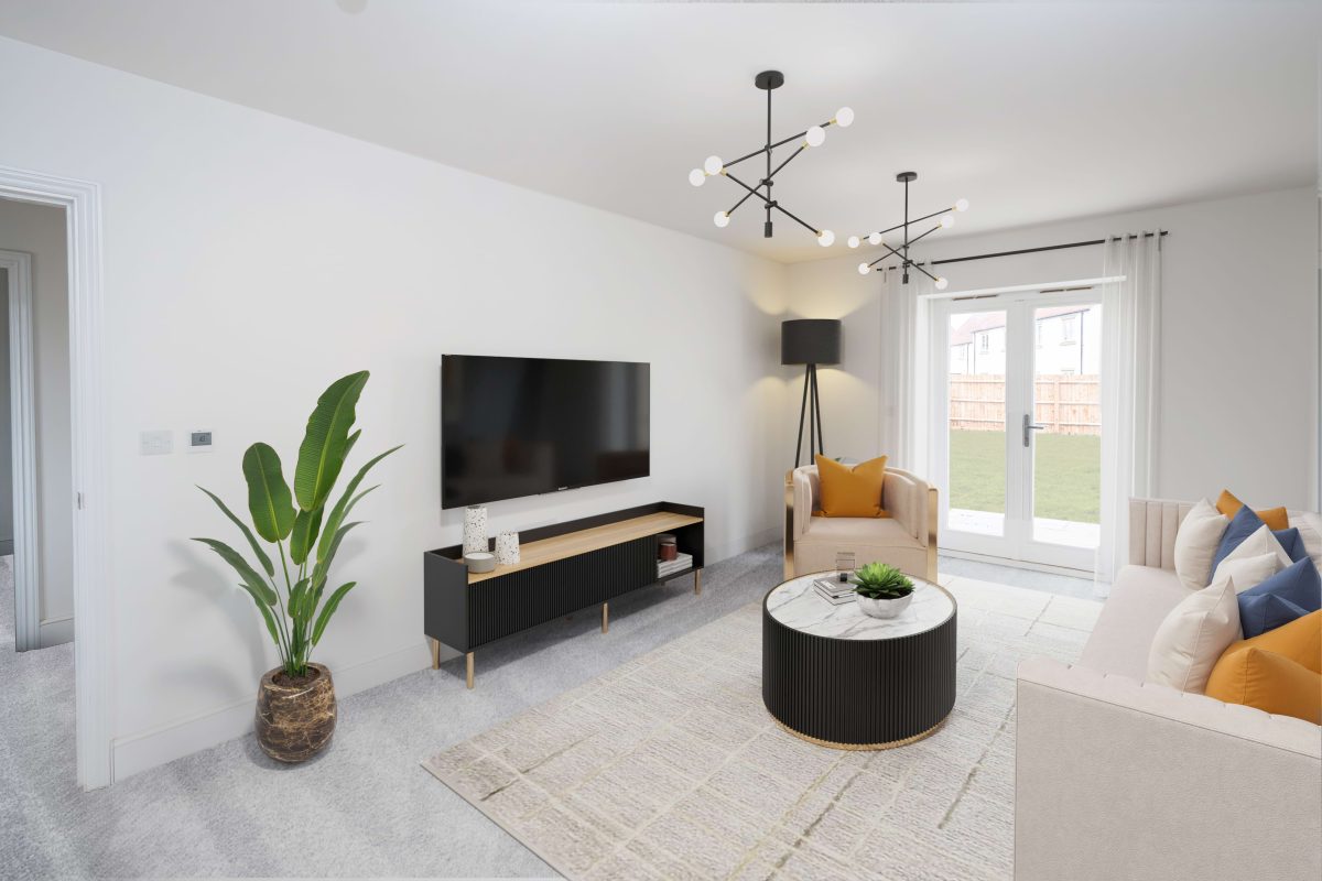 Living room with a grey sofa, round coffee table, wall-mounted television and French doors onto the garden