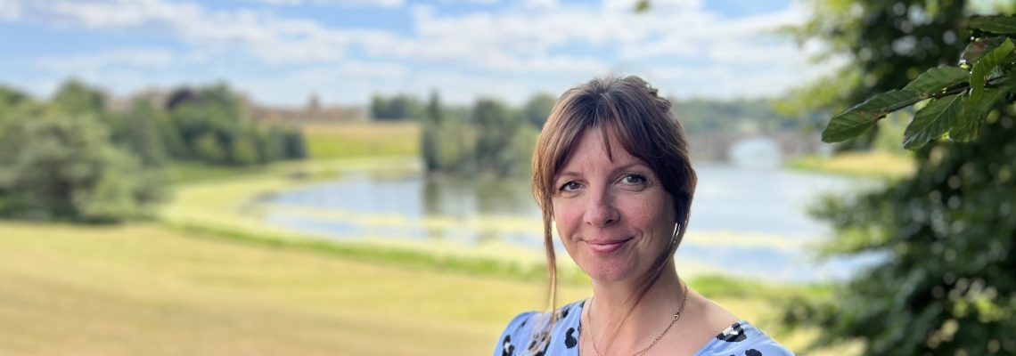 Merilyn Davies, the Estate's Community Officer, in Blenheim Park with the lake and Grand Bridge behind