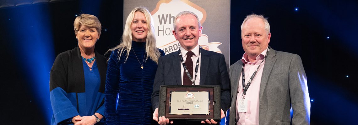 Four people on stage holding the WhatHouse? Award for Best Partnership Scheme for Park View