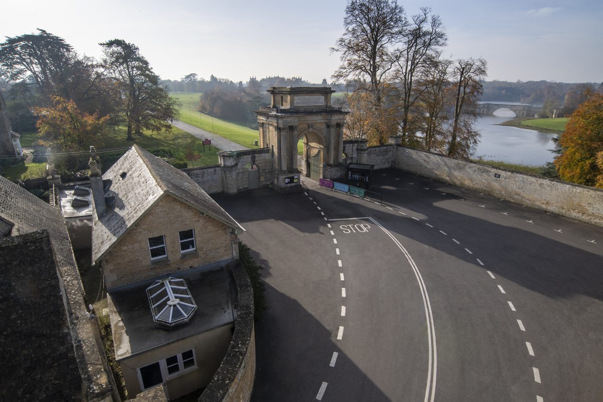 Aerial view of Woodstock Lodge beside the triumphal arch at the Woodstock entrance to Blenheim Park, with the lake and Grand Bridge beyond